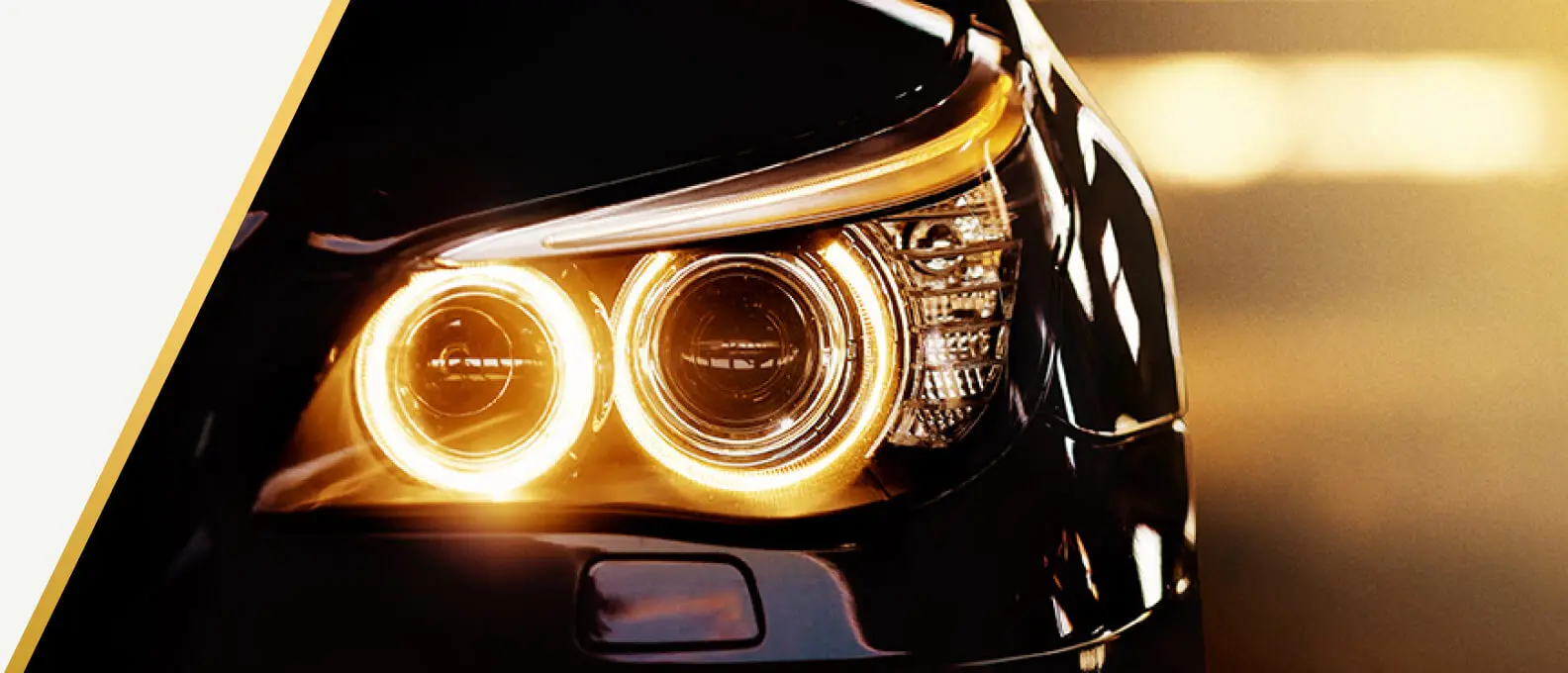 Close-up of a car headlight glowing at dusk