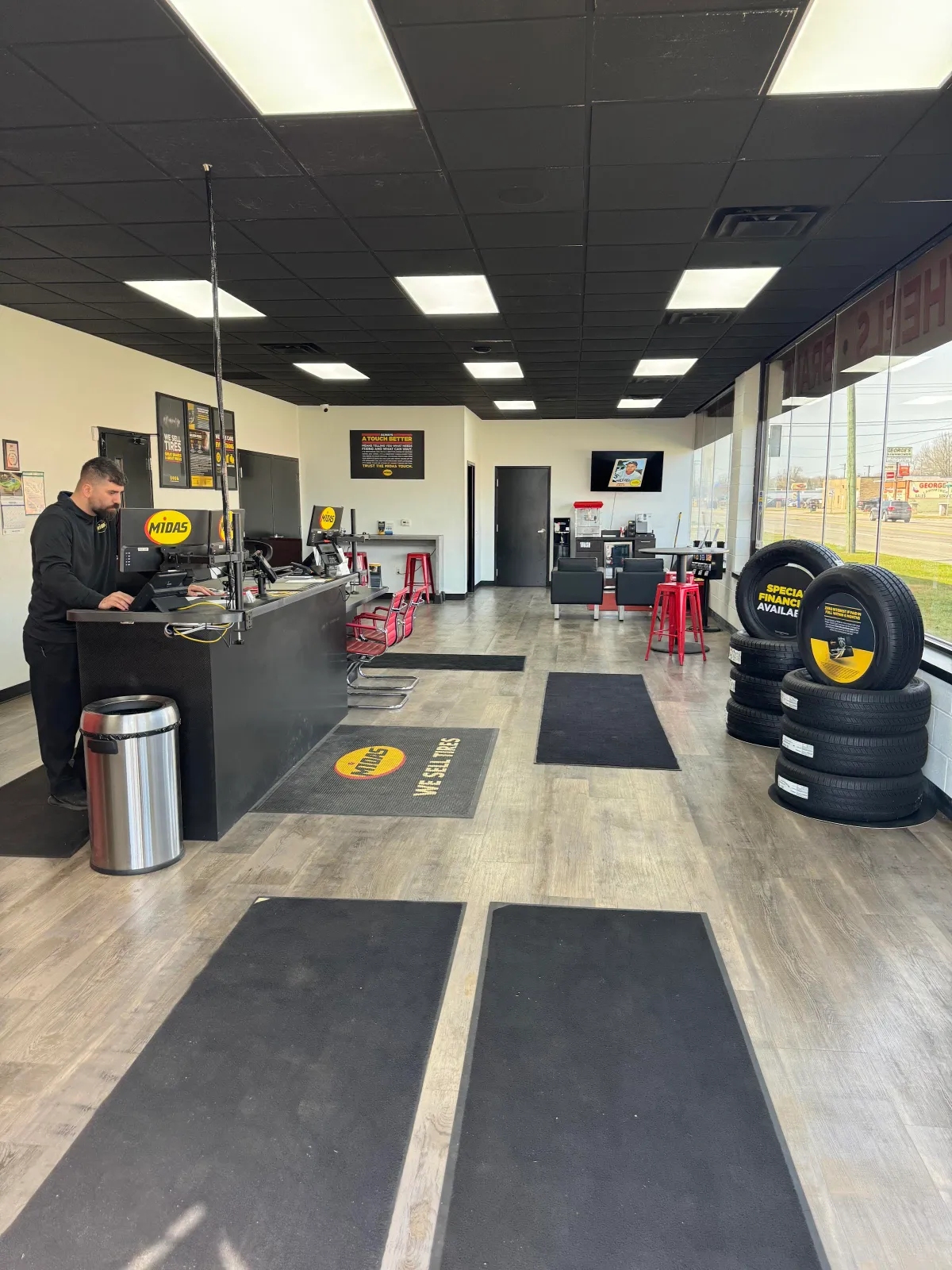 Bright customer lobby and service desk at Midas Redford, with tires on display