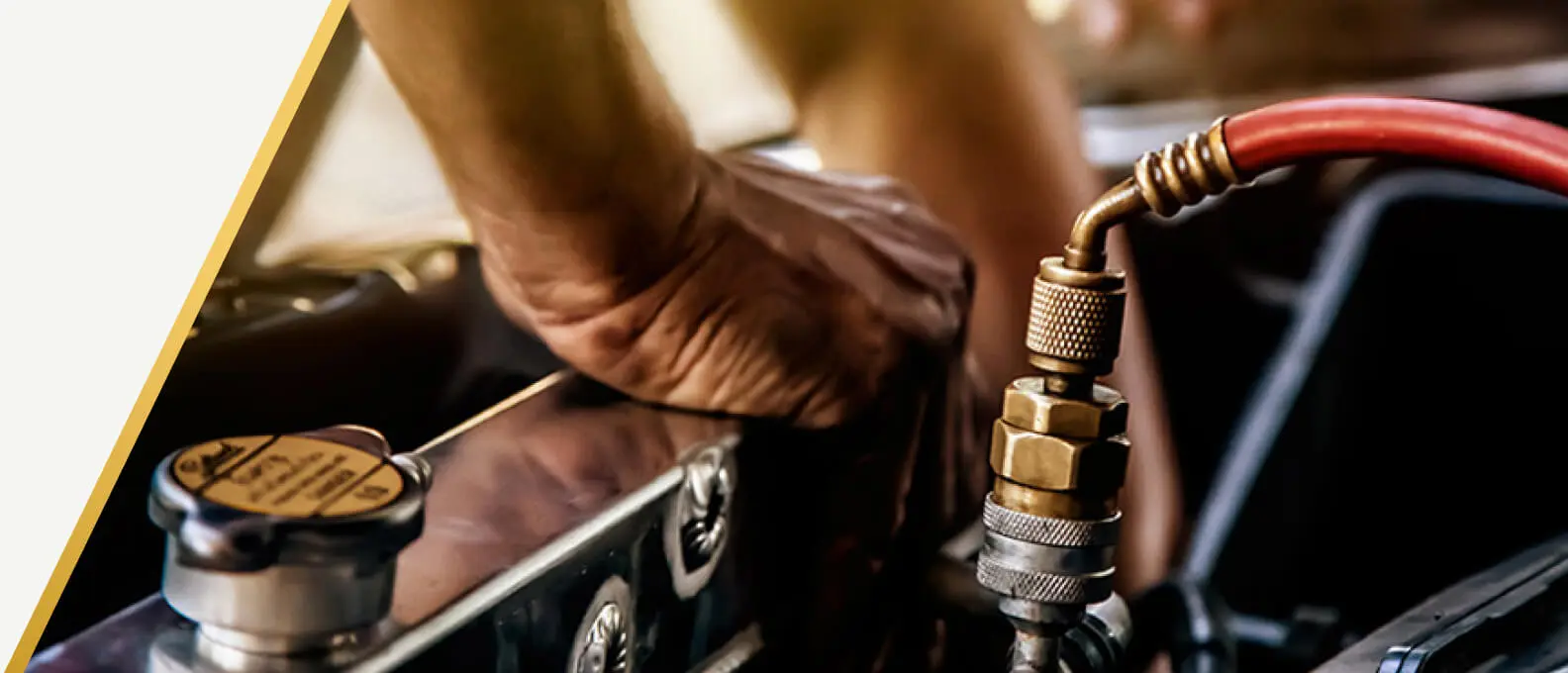 Technician servicing the radiator and cooling lines under the hood