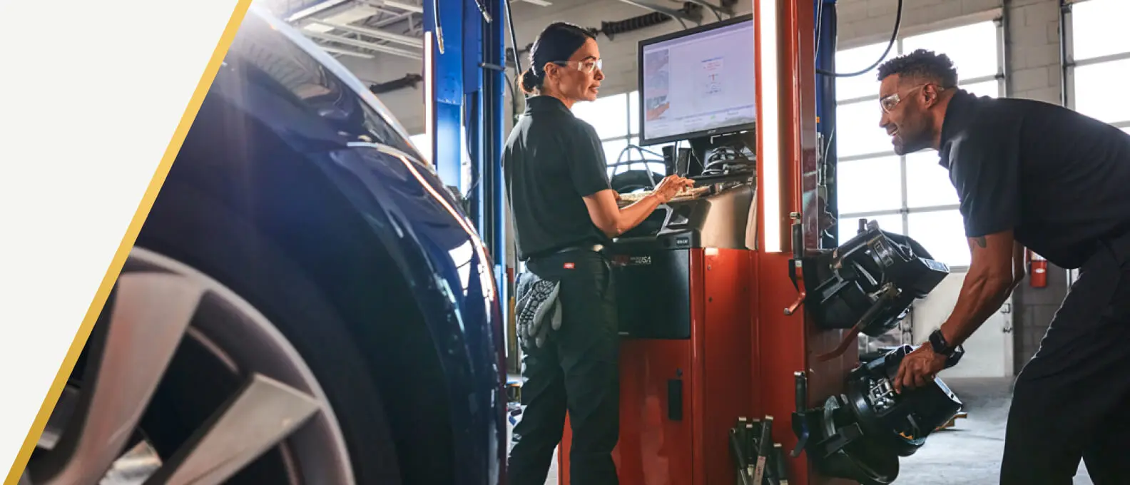 Technicians at an alignment machine